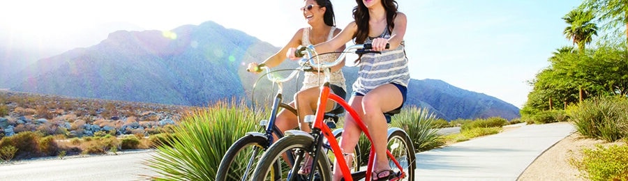 Two women riding their bikes