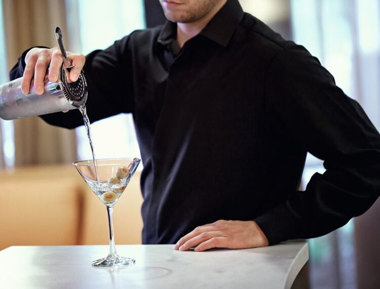 man pouring martini
