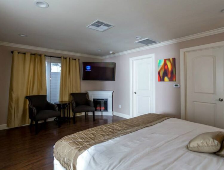King room tv and accent chairs at Little Paradise Hotel