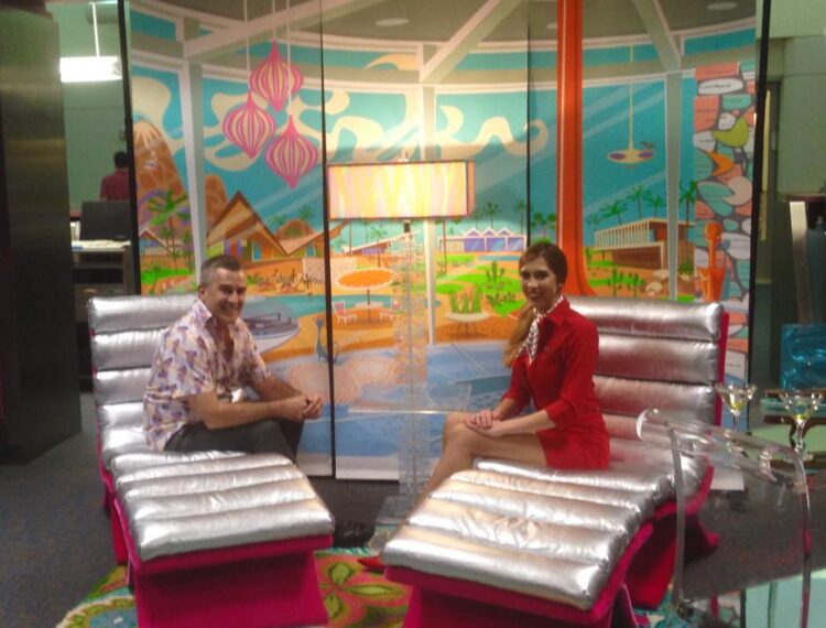 two people sitting on chairs in studio