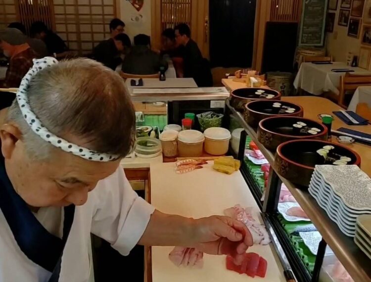 man making sushi