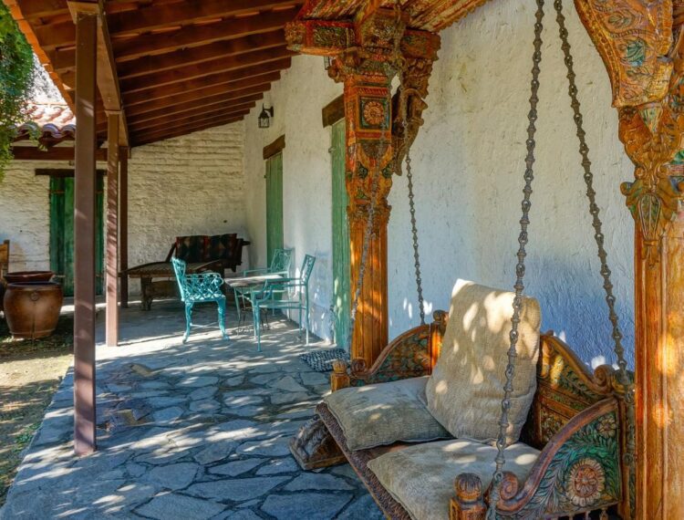 Casa Cody guestroom patio with restored antique porch swing