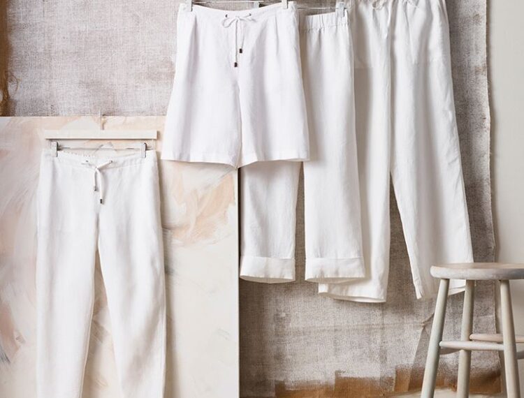 white skirt and pants hanging on wall