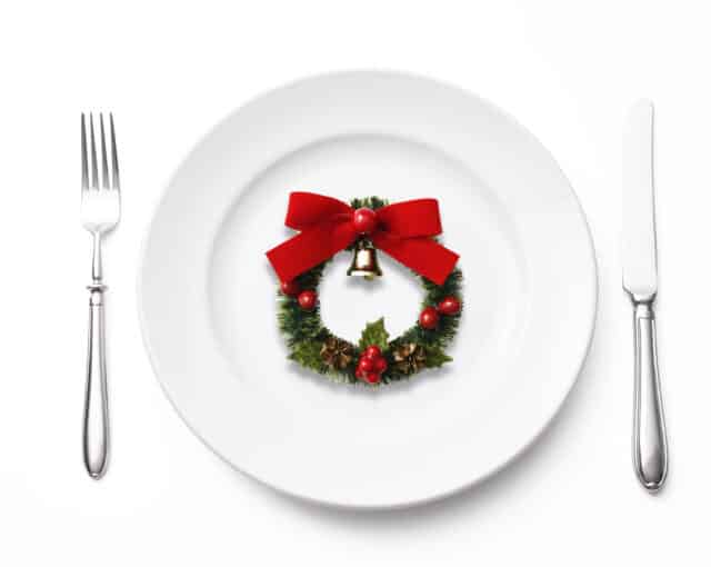 Overhead shot of place setting and Christmas Wreath, isolated on white background with clipping path.