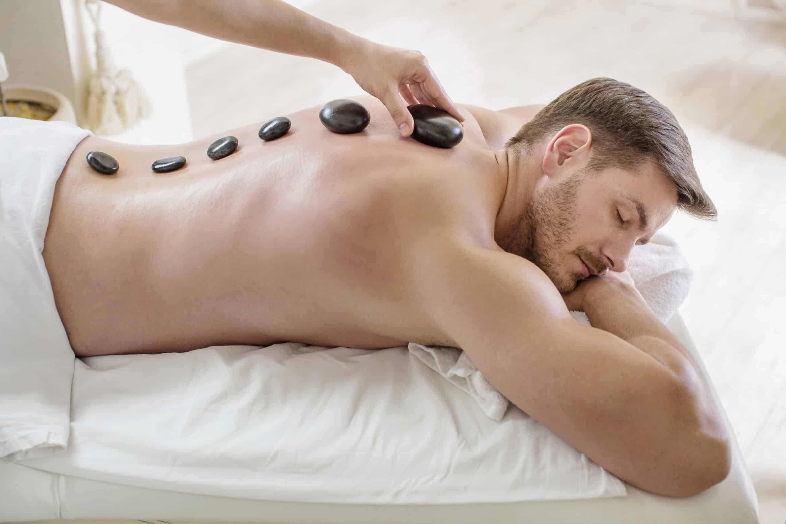 Man having stone massage in spa salon